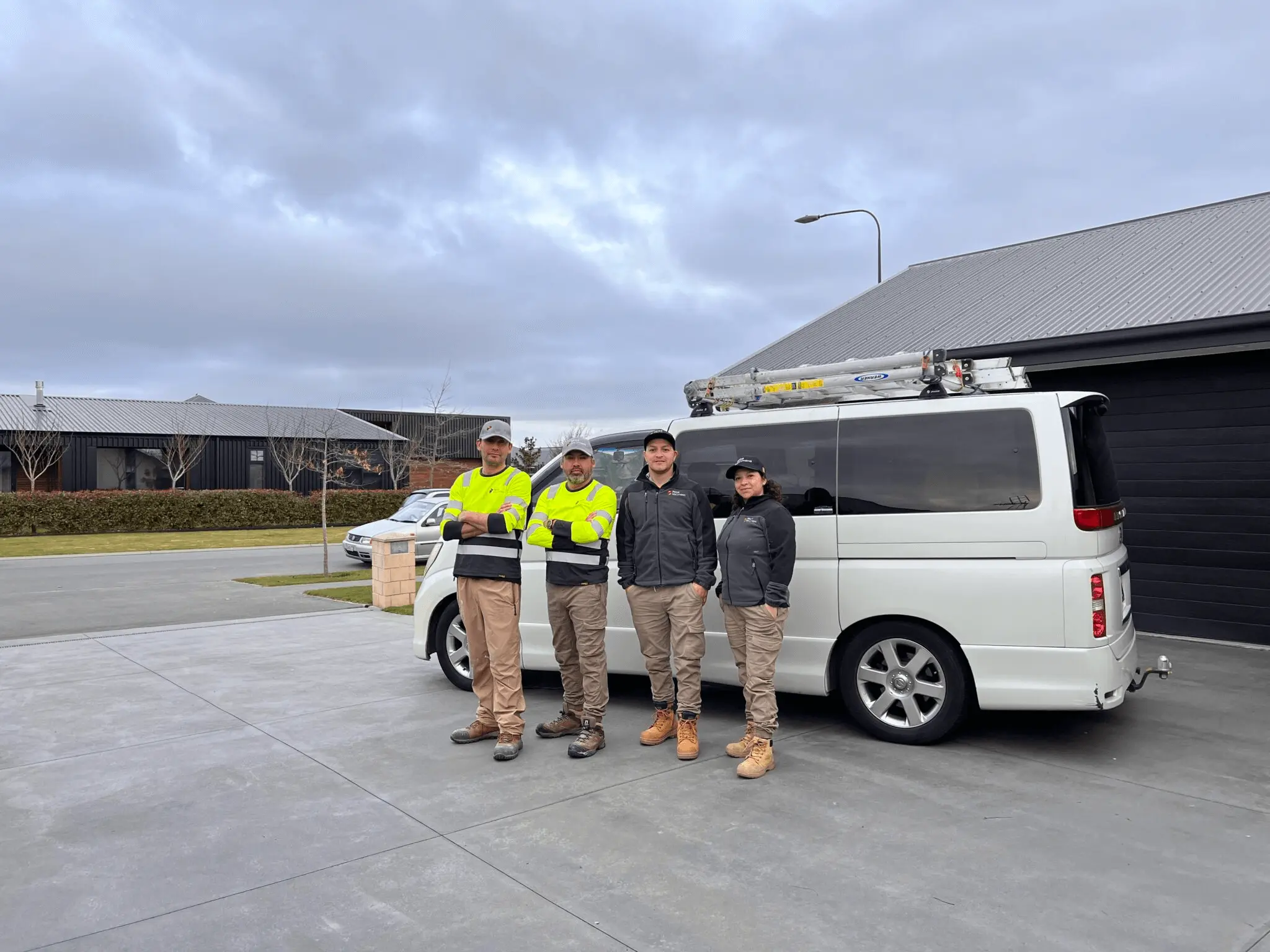 Painting crew standing infront of a work van